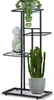 A black metal plant stand with four tiers, holding three potted plants and a decorative bust. Náhled obrázku produktu