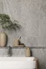 A bathroom sink area with tiled walls, a faucet, and various accessories. Anteprima dell’immagine prodotto