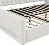 Close-up view of the side and slatted base of a white upholstered bed frame. Náhled obrázku produktu