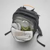 An open backpack with items inside, shown from a top-down diagonal angle. Náhled obrázku produktu