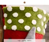 A close-up view of a Christmas stocking with polka dots and a grey cone-shaped element. Náhľad obrázku produktu