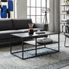 A modern living room with a dark gray sofa, a black coffee table with a chemex coffee maker and candles on it, and a large abstract painting on the wall. Náhľad obrázku produktu