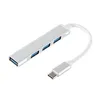 A silver USB C hub with four USB 3.0 ports and a USB C connector is shown on a white background. Produktbild-Vorschau