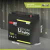 A black lithium battery with yellow and white accents is shown in a studio-like setting with a dark, textured background and green lights. Produktbild-Vorschau