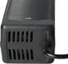 A close-up view of a black power adapter with ventilation slots. Produktbild-Vorschau