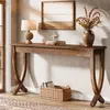 A console table with decorative items and books in a room. Anteprima dell’immagine prodotto