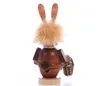 A wooden figurine of a rabbit from behind, holding a basket of mushrooms. Produktbild-Vorschau