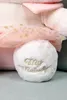 Close-up of a plush toy's foot with embroidered text. Podgląd zdjęcia produktu