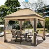A gazebo set up on a wooden deck in a backyard, with chairs and a table underneath. Produktbild-Vorschau