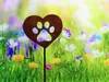 A rusty heart-shaped garden stake with a paw print cutout is placed in a field of colorful wildflowers. Produktbild-Vorschau