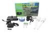 A product shot of an electronic dog fence system and its components, laid out on a white background, with the product's packaging in the background. Produktbild-Vorschau