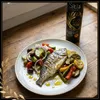 Sitia Premium Gold 0,2 % Olivenöl Glasflasche mit gegrilltem Fisch und Gemüsegarnitur Produktbild-Vorschau