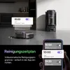 A robotic vacuum cleaner and its charging station are shown in a modern home setting, with app notifications displayed on a smartphone. Produktbild-Vorschau