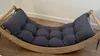 A gray cushion on a wooden rocking cradle. Produktbild-Vorschau