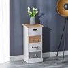 A narrow chest of drawers with four drawers, decorated with a vase of white tulips on top, placed against a dark blue wall. Produktbild-Vorschau