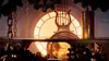A close-up view of a complex clockwork mechanism with a large illuminated clock face in the background. Náhled obrázku produktu
