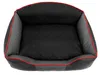 A top-down view of a black and gray dog bed with red trim, set against a white background. Produktbild-Vorschau