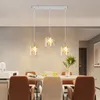 A dining room setting with a chandelier hanging over a table. Produktbild-Vorschau