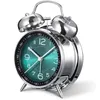 A close-up studio shot of a silver retro alarm clock with a green face. Voir les images du produit