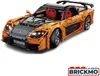 A detailed model of an orange sports car, constructed from building blocks, is shown from a slightly elevated front-side angle against a white background. Anteprima dell’immagine prodotto
