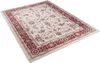 A rectangular rug with a floral pattern and a decorative border, shown from a diagonal angle on a white background. Náhľad obrázku produktu