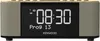 A close-up front view of a digital clock radio with a wood-grain top and fabric speaker grilles on the sides. The display shows the time and program information. Produktbild-Vorschau