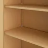 Close-up view of the interior of a beige metal cabinet with shelves. Produktbild-Vorschau