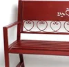 A close-up view of a red metal garden bench. Produktbild-Vorschau