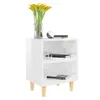 A white nightstand with two shelves, decorated with yellow flowers in a vase and two books. Produktbild-Vorschau