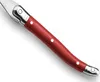A close-up view of the handle of a knife, showing the red handle with silver rivets and a silver metal end. Anteprima dell’immagine prodotto
