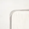 A close-up view of the corner of a white bath mat, showing its textured surface and bound edge. Produktbild-Vorschau
