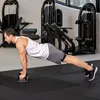 A man is doing push-ups in a gym using push-up bars. Produktbild-Vorschau