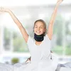A woman is stretching in bed while wearing a neck brace. Produktbild-Vorschau