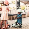 Two young children are playing with scooters outdoors on a wooden deck. Podgląd zdjęcia produktu