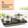 A double induction cooktop with two pots on it, set against a light background with greenery visible through a window. Produktbild-Vorschau