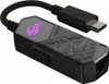 A close-up studio shot of a black ASUS ROG Clavis AI Noise Cancelling Mic Adapter with a USB-C connector. Podgląd zdjęcia produktu