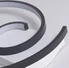 A close-up view of a modern, black, spiral-shaped LED ceiling lamp, showing its sleek design and material. Produktbild-Vorschau