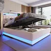 A modern bedroom with a bed that has its storage compartment open, revealing the mattress and bedding. The bed frame is illuminated with blue LED lights. Produktbild-Vorschau