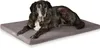 A dog is lying on a gray dog bed. Produktbild-Vorschau