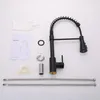 A black kitchen faucet and its accessories are laid out on a white background. Podgląd zdjęcia produktu