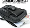 A black utility pouch with a phone and playing cards partially visible inside, set against a white background. Podgląd zdjęcia produktu