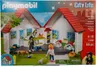 The image shows the packaging of a Playmobil City Life portable pet store playset. The packaging displays the product with figures and accessories, along with branding and product information. Produktbild-Vorschau