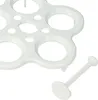 A close-up of a white plastic egg holder and a separate white plastic egg piercer, both on a white background. Produktbild-Vorschau