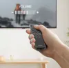 A hand holding a remote control in front of a TV screen displaying a volume bar. Produktbild-Vorschau
