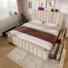 A bedroom scene with a bed and surrounding furniture. Náhľad obrázku produktu