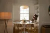 A woman and child are using a laptop at a dining table. Produktbild-Vorschau