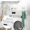 A white washing machine with a drawer unit above it, featuring laundry detergent and a green towel. Podgląd zdjęcia produktu
