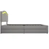 A side view of a gray upholstered bed frame with a headboard featuring yellow LED lighting and two drawers underneath. Anteprima dell’immagine prodotto