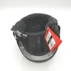 The inside of a black ski helmet with a red tag attached. Voir les images du produit