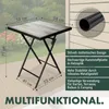A square folding table with a wood-like finish and metal frame, shown on a deck with a blurred background of greenery and flowers. Dimensions and descriptive text are overlaid. Produktbild-Vorschau